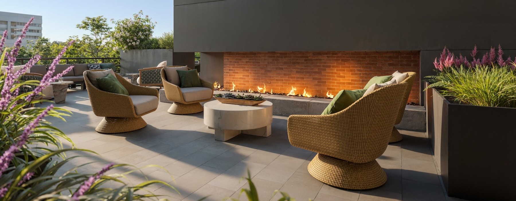 a patio with a fireplace and chairs
